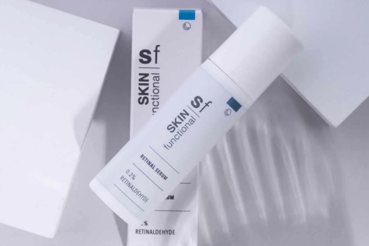 SKIN Functional retinal serum skin treatment with details skincare product on a grey background