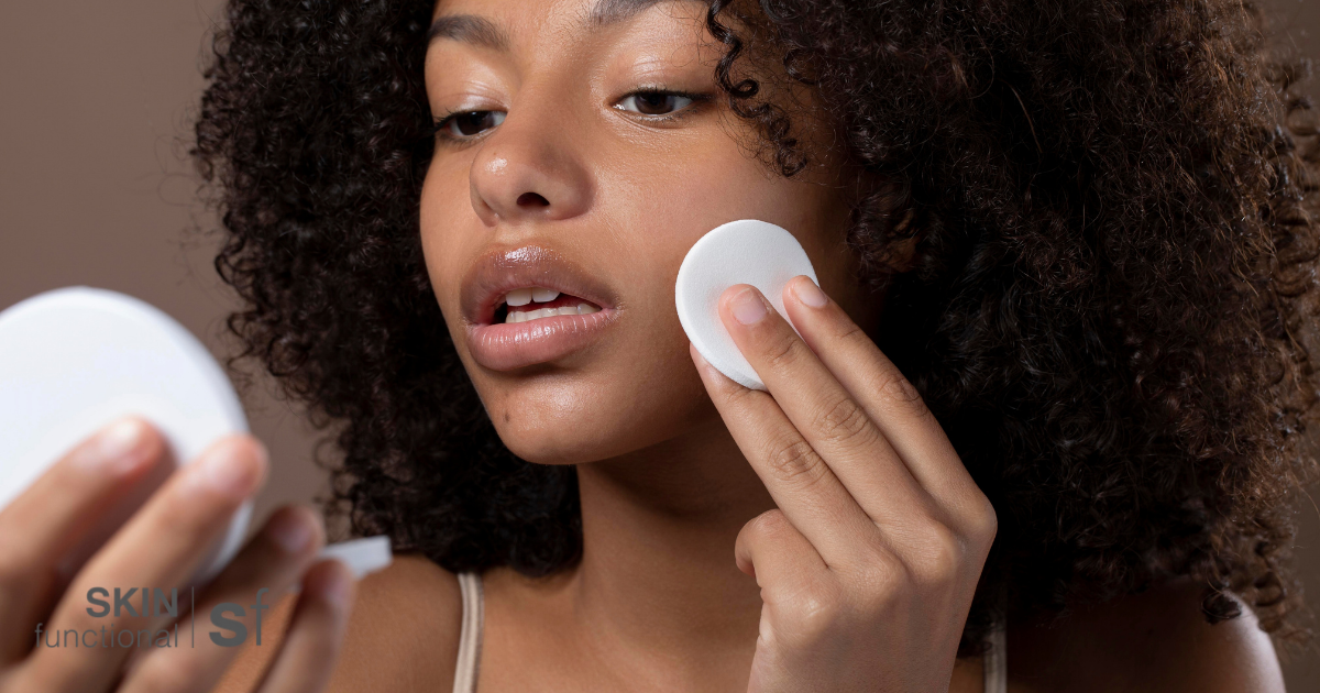 Applying toner to skin with a cotton pad