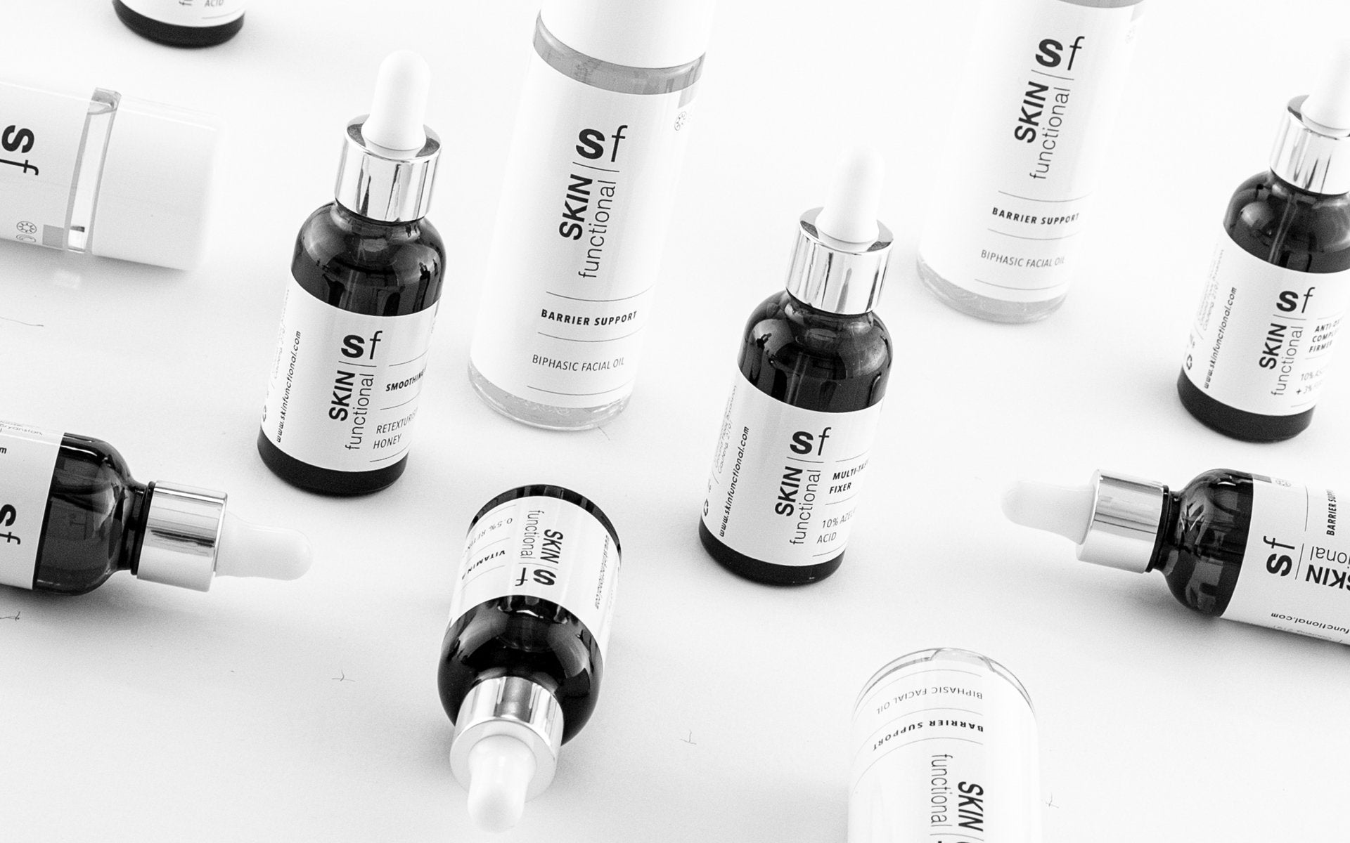 Collection of skincare serum bottles on a white background