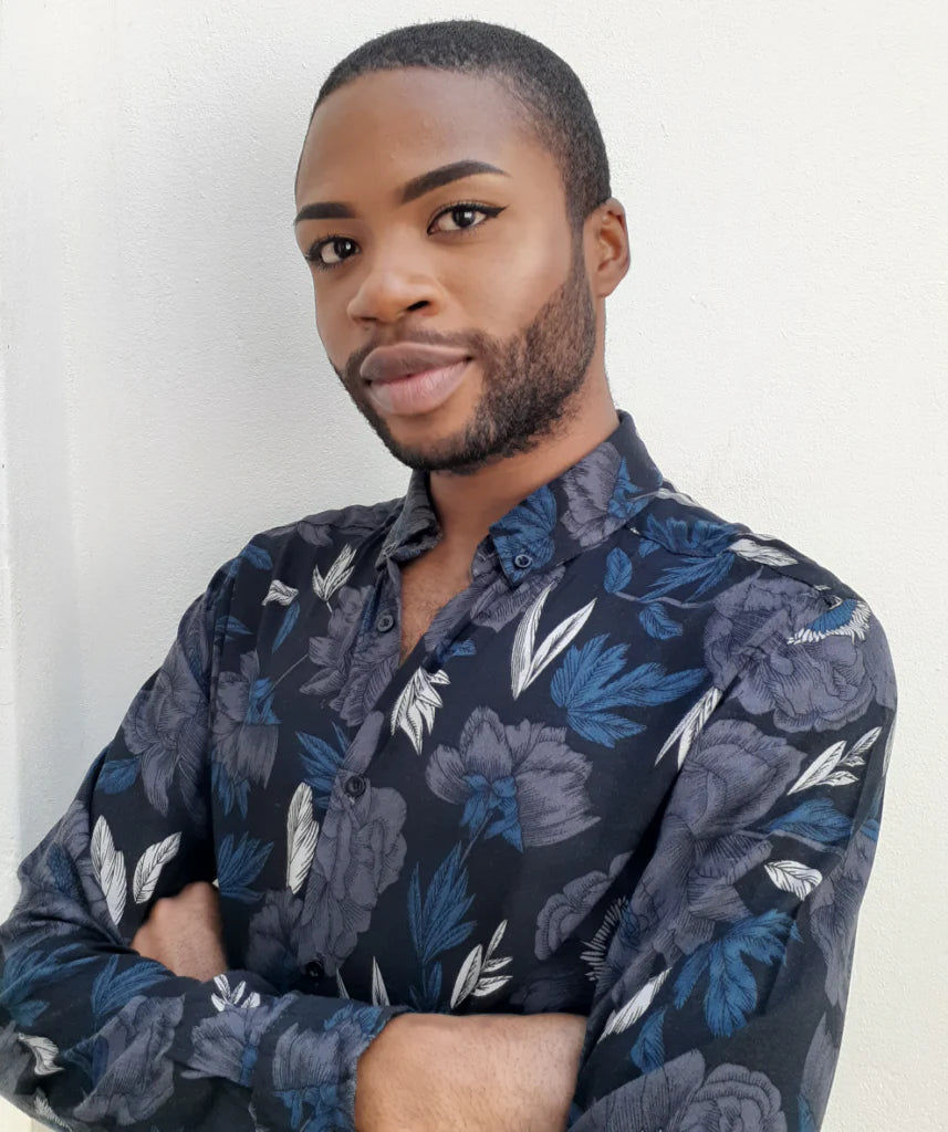 Man wearing a dark floral shirt against a white background