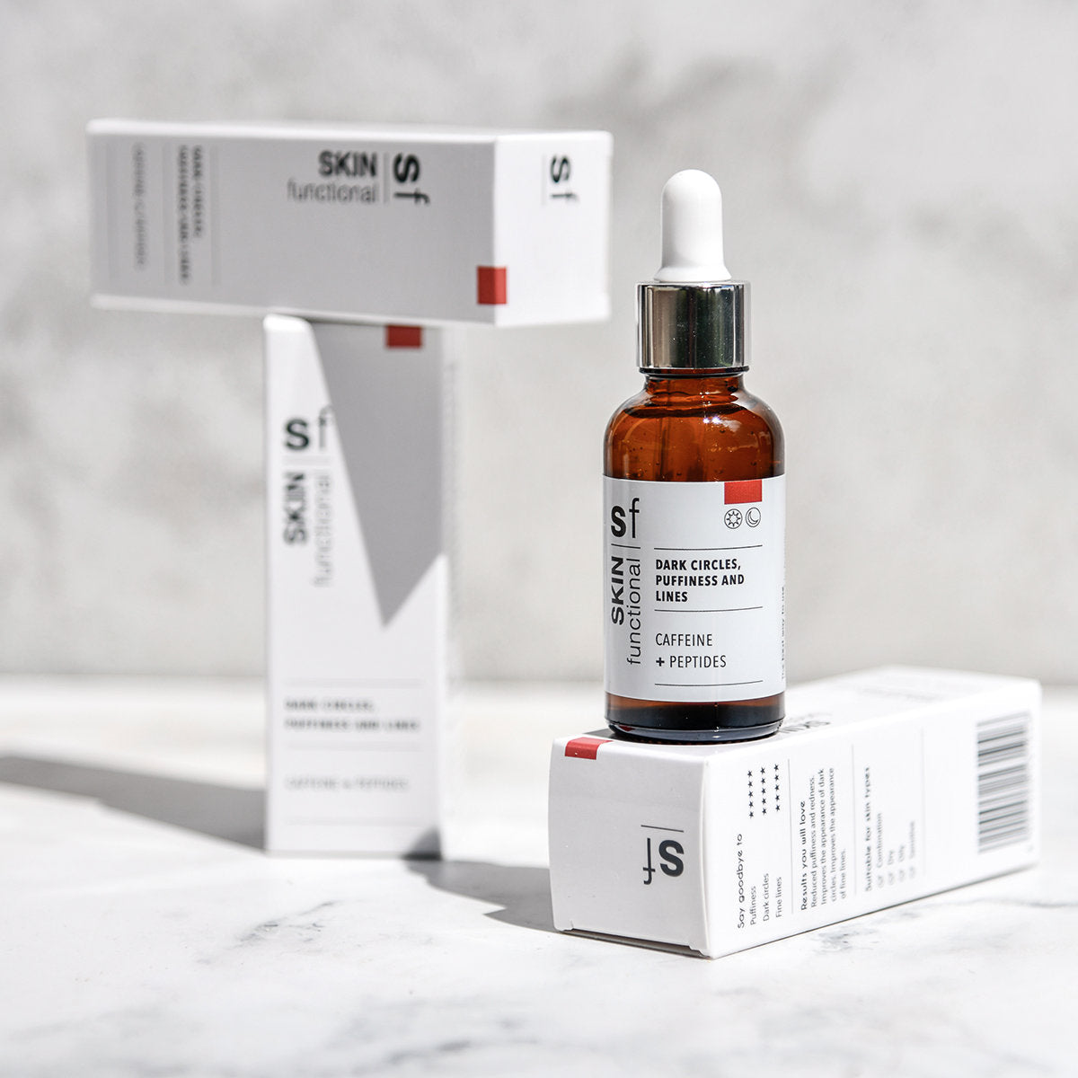 SKIN Functional dark circles, puffiness and lines treatment with details skincare product on a grey background