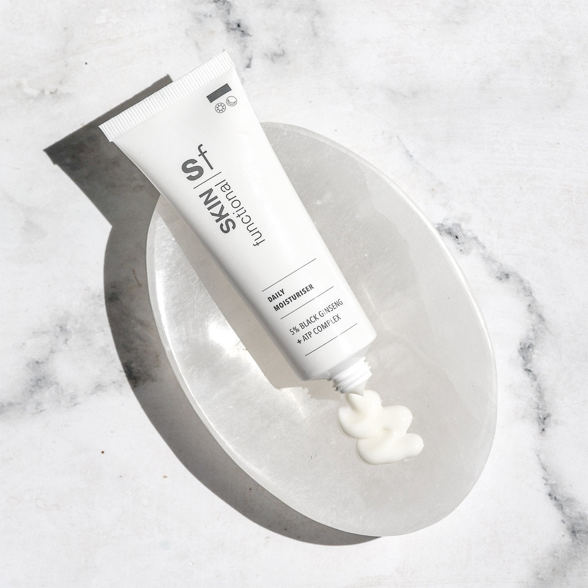 SKIN Functional daily moisturiser with details skincare product on a grey background