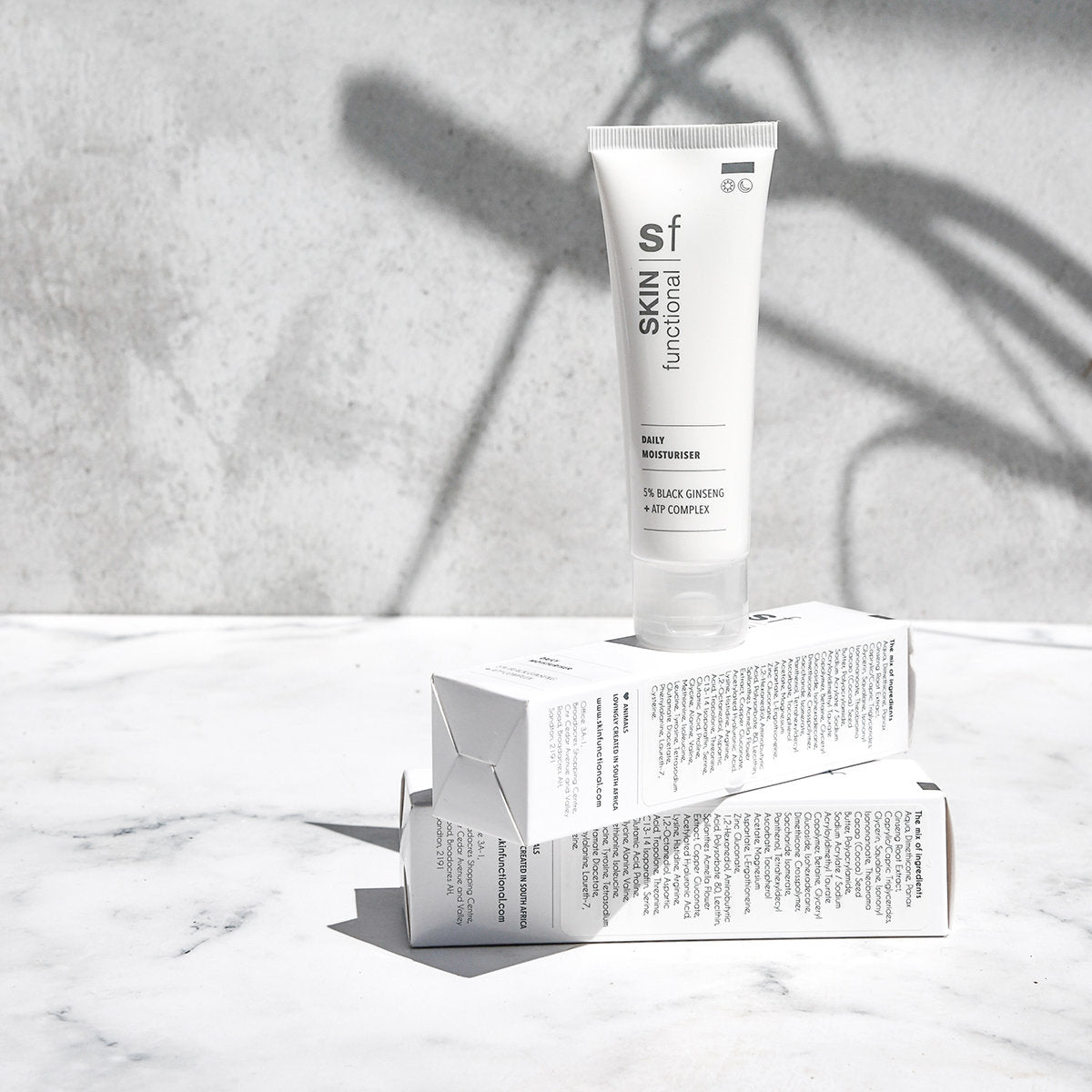 SKIN Functional daily moisturiser with details skincare product on a grey background