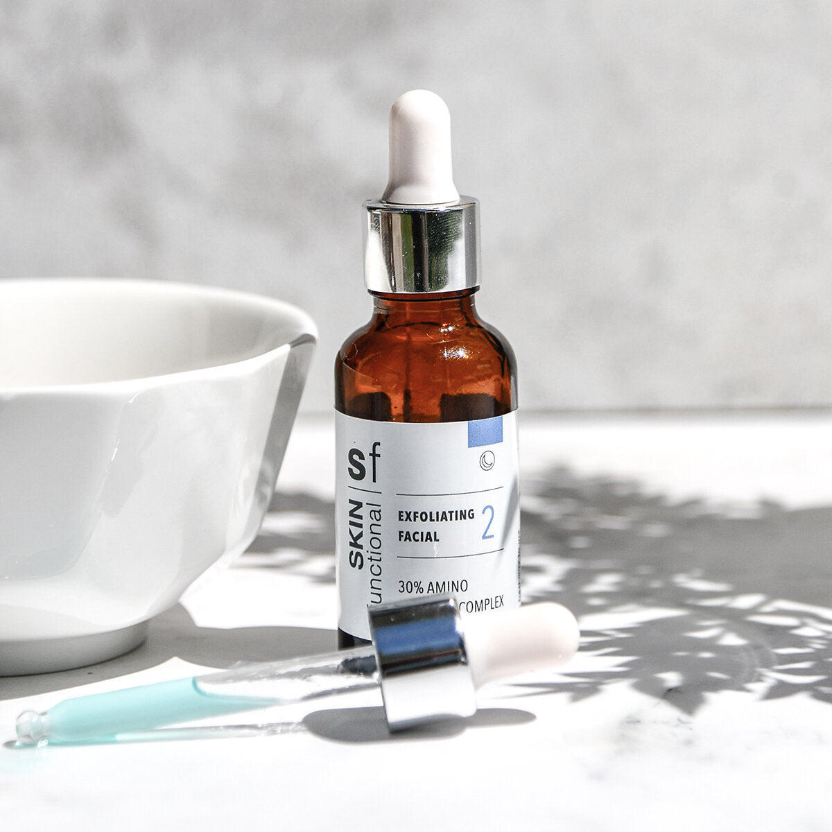 SKIN Functional exfoliating facial treatment with details skincare product on a grey background