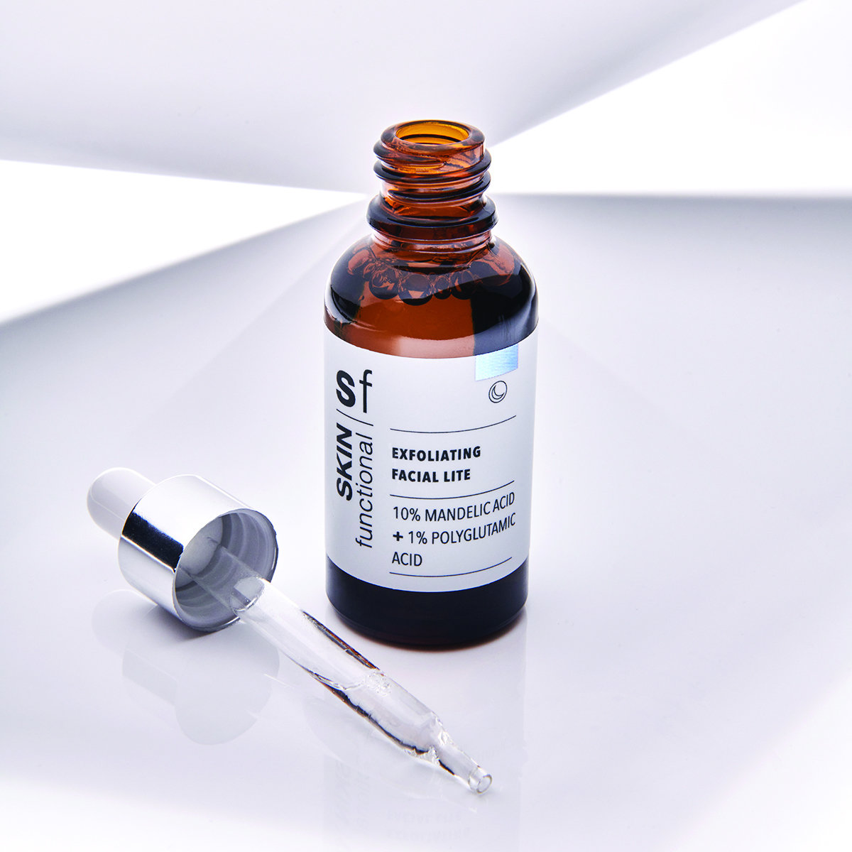 SKIN Functional Exfoliating Facial Lite with details skincare product on a light gray background