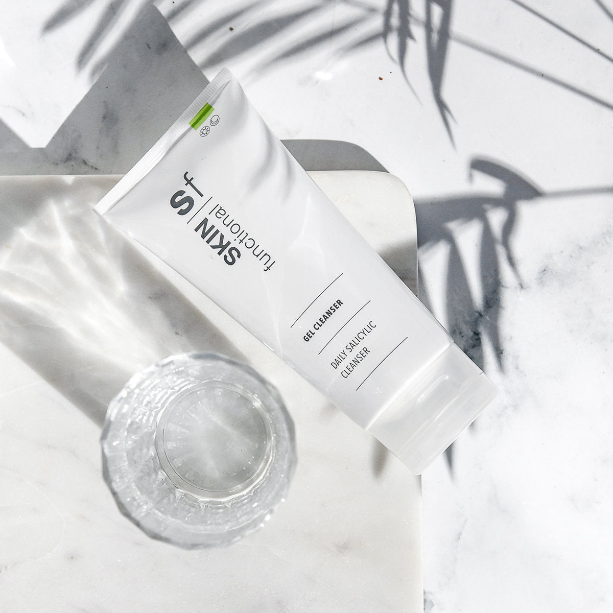 SKIN Functional Salicylic Cleansing Complex Gel Cleanser with details skincare product on a grey background