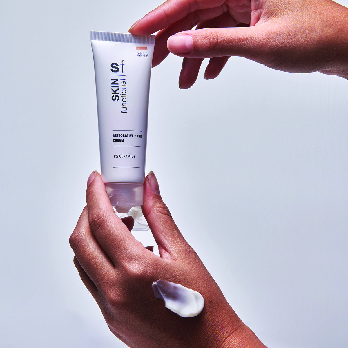 SKIN Functional Restorative Hand Cream with details skincare product on a light gray background