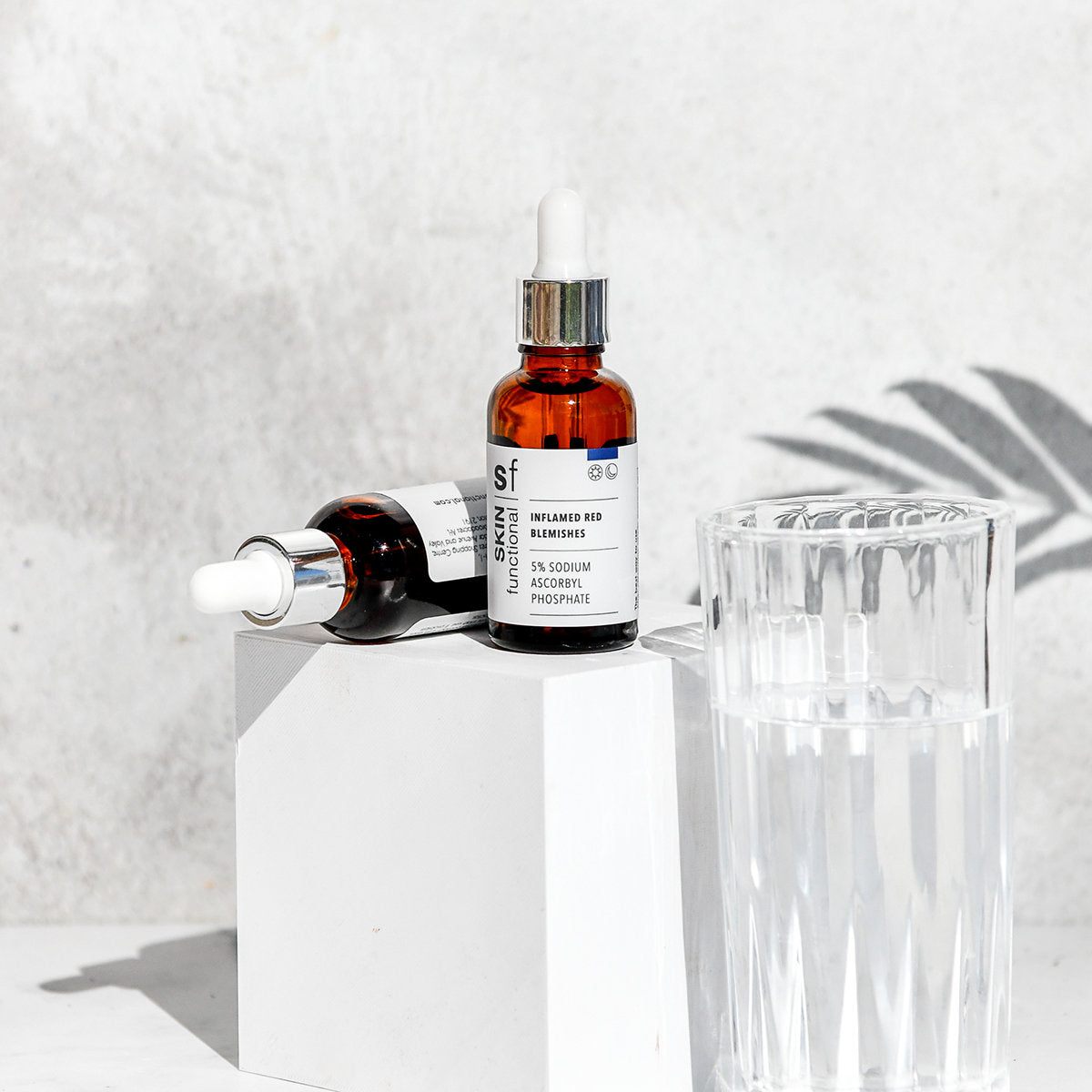 SKIN Functional Inflamed Red Blemishes with details skincare product on a grey background