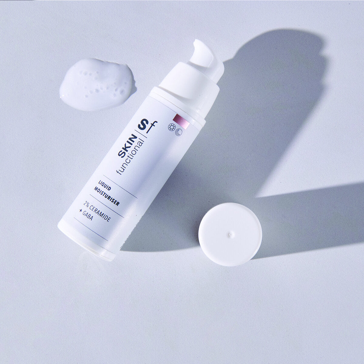 SKIN Functional liquid moisturiser with details skincare product on a grey background