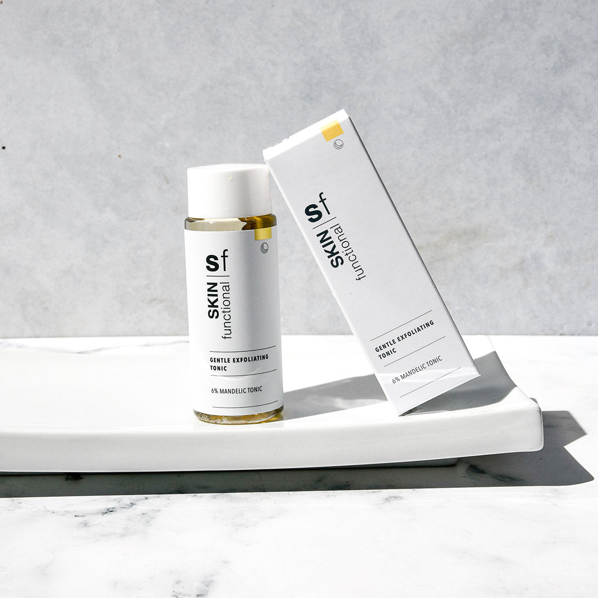 SKIN Functional gentle exfoliating tonic with details skincare product on a grey background