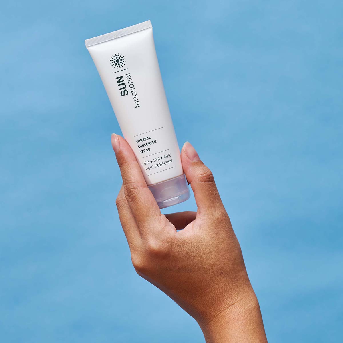 SKIN Functional Mineral Sunscreen SPF 50 with product details skincare product on a light gray background