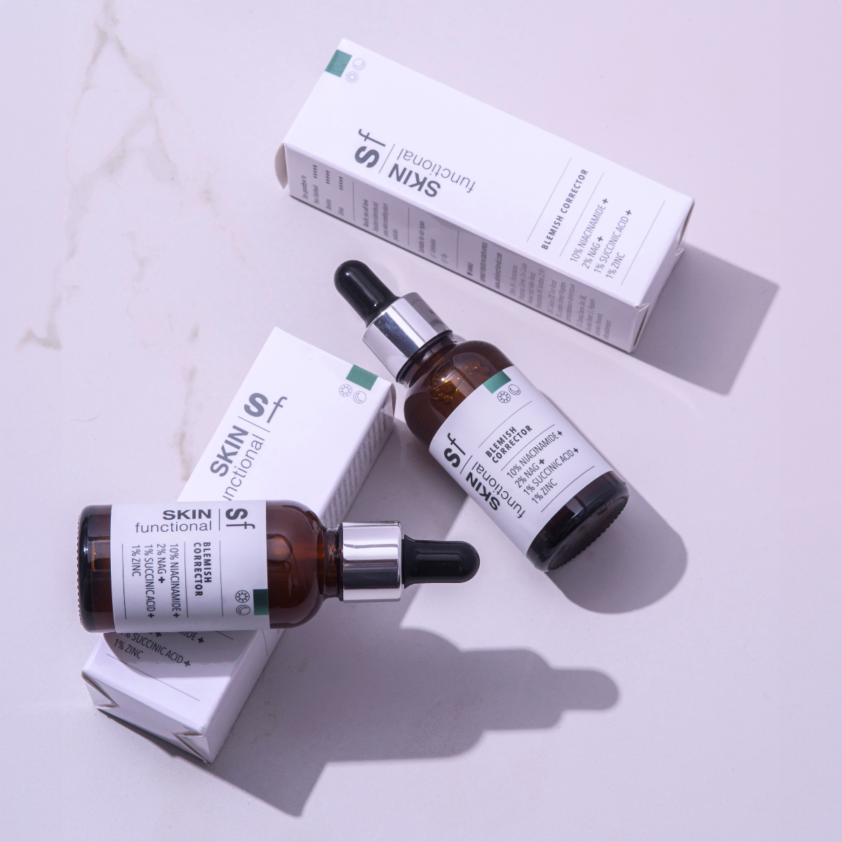 Hand holding a Skin Functional Blemish Corrector Bottle