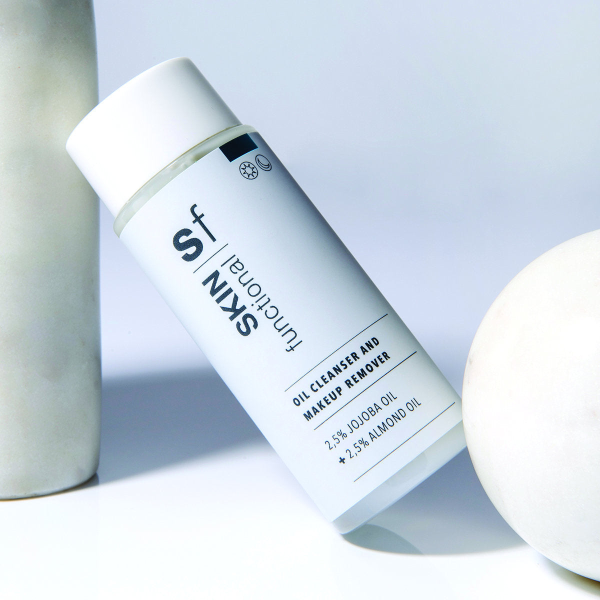 SKIN Functional Oil Cleanser and Makeup Remover with details skincare product on a light gray background