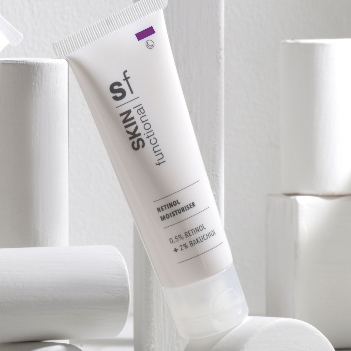 SKIN Functional Retinol Moisturiser with details skincare product on a light gray background