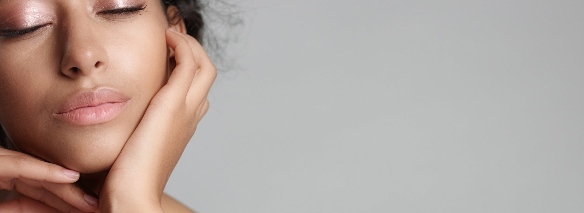 Close-up of a woman's face with a neutral background 